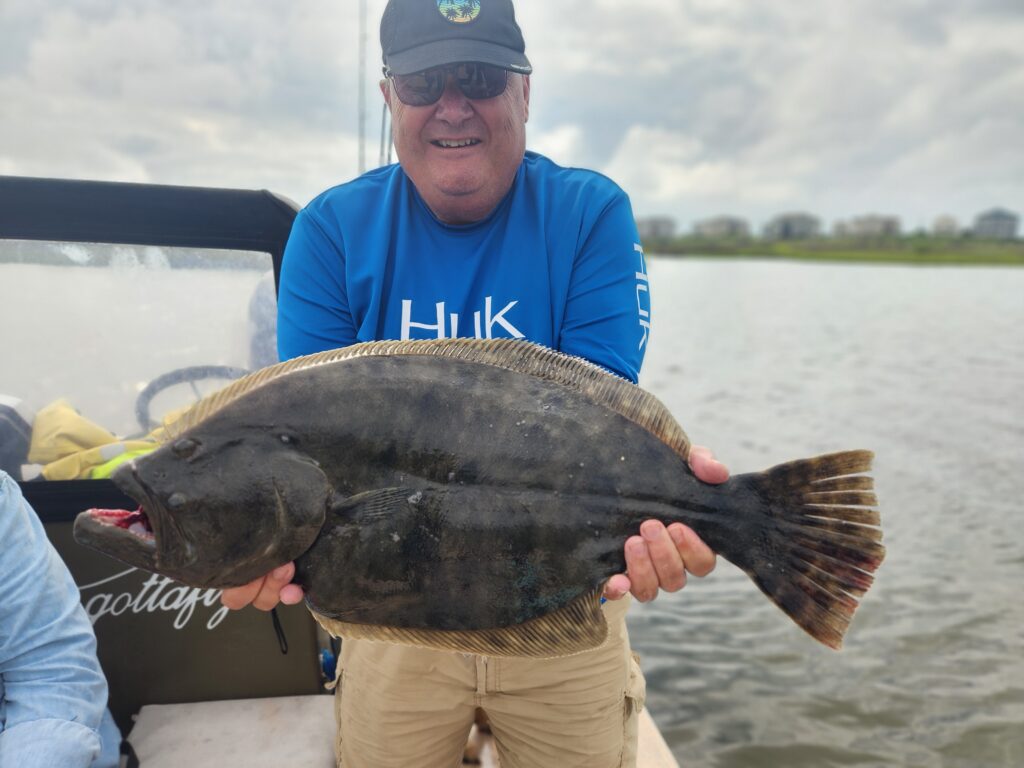 Fishing Incognito | gottafly guide service | Captain Lee Parsons | Male angler holding a large red Grouper.