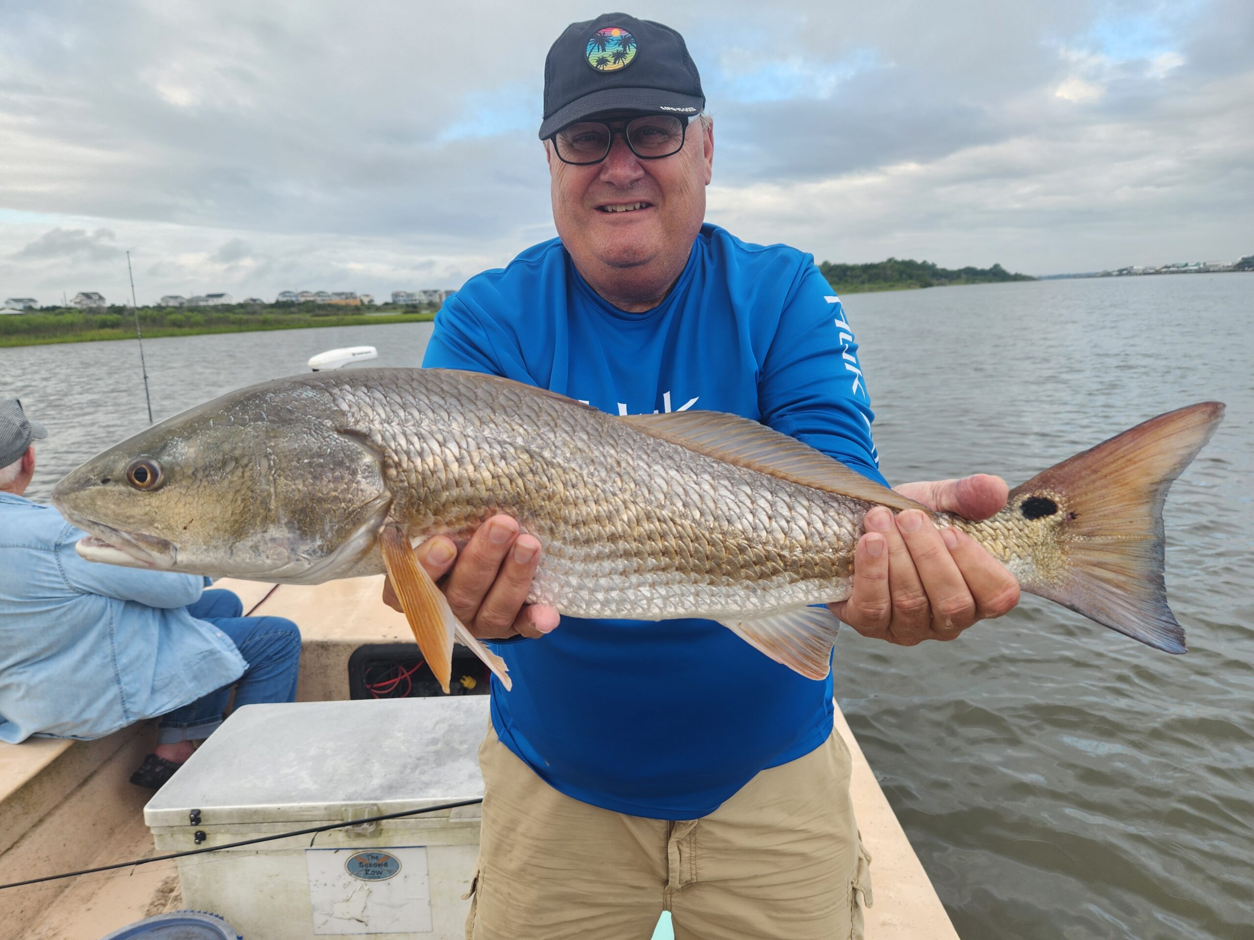 Fishing Incognito | gottafly guide service | Captain Lee Parsons | Male angler holding a large red drum.