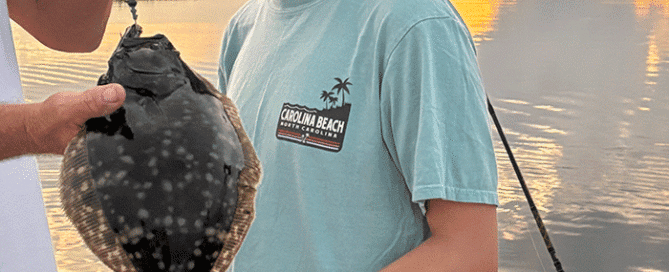 Young female angler holding a caught flounder.