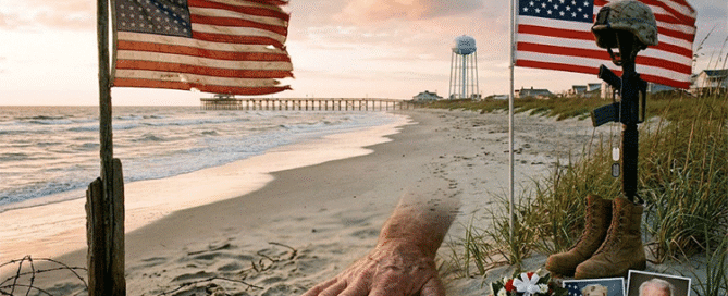 A Memorial Day tribute on a Topsail Island beach, honoring the meaning of Memorial Day with a soldier's battlefield cross, an American flag, and memorial photos representing generations of military sacrifice.